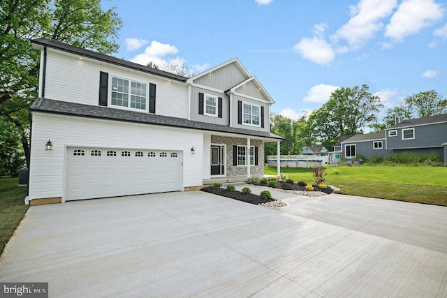 view of front of property featuring concrete driveway, a front yard, covered porch, and a garage