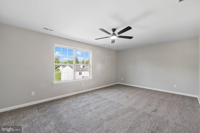 empty room with baseboards, a ceiling fan, and carpet floors