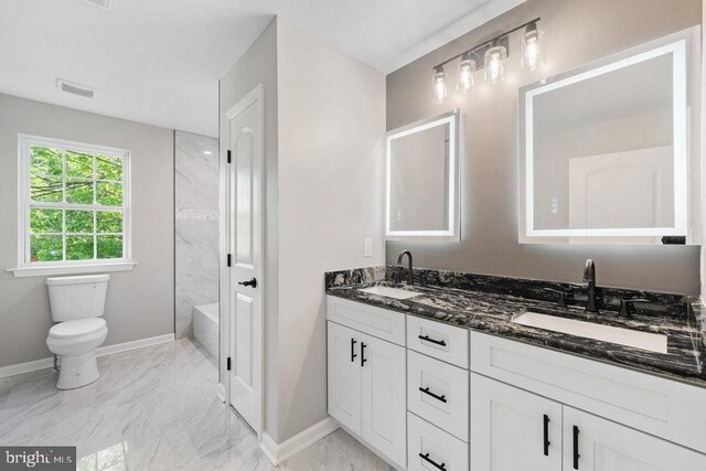 bathroom with marble look tile flooring, baseboards, double vanity, and toilet