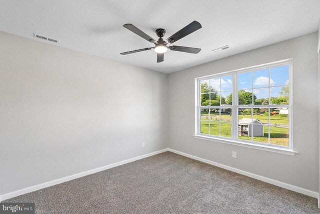 unfurnished room with baseboards, carpet floors, and ceiling fan