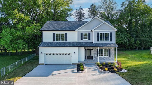 view of front of house with a garage, driveway, covered porch, a shingled roof, and stone siding