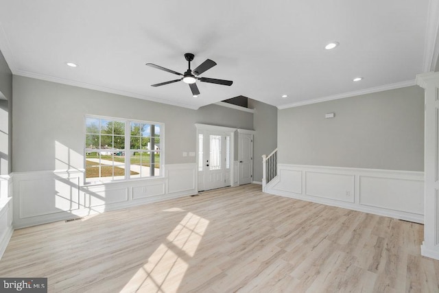 unfurnished living room with a decorative wall, ceiling fan, ornamental molding, stairs, and recessed lighting