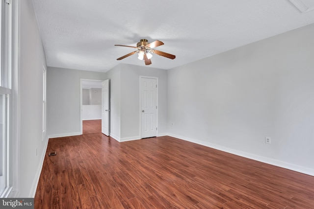 unfurnished bedroom featuring baseboards and dark wood finished floors
