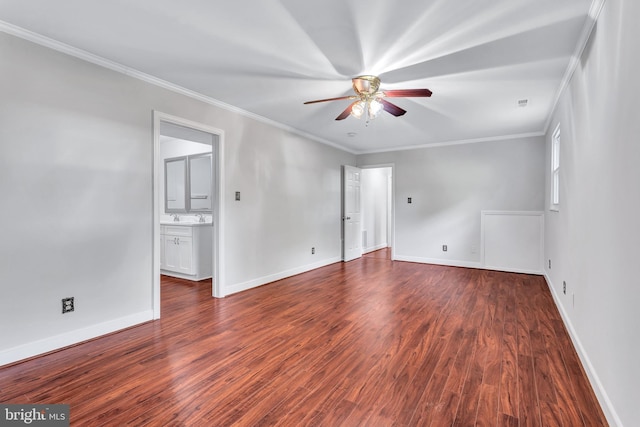 unfurnished room featuring baseboards, wood finished floors, a ceiling fan, and crown molding