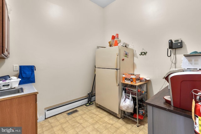 196 E Main St, Westminster, MD 21157 - kitchen featuring visible vents, freestanding refrigerator, light floors, and baseboard heating