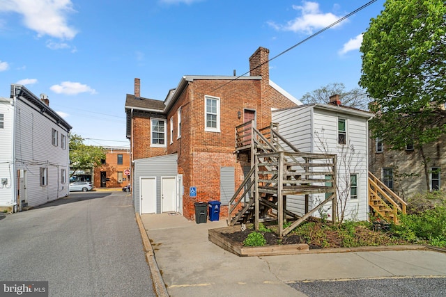 196 E Main St, Westminster, MD 21157 - view of front of house featuring brick siding, a chimney, and stairway