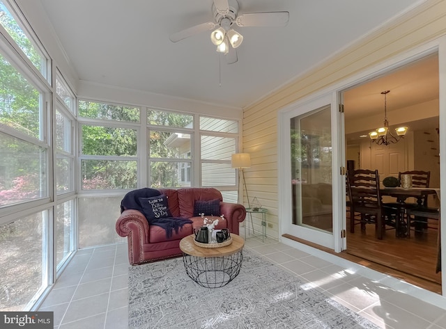 sunroom featuring tile patterned floors, plenty of natural light, and ornamental molding