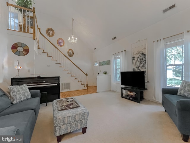 living room featuring visible vents, a wealth of natural light, and stairway