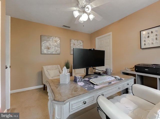 home office with baseboards, a ceiling fan, light colored carpet, and visible vents