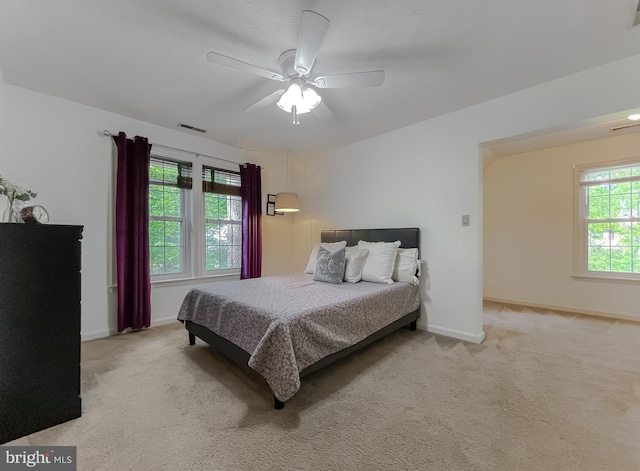 bedroom featuring carpet floors, a ceiling fan, baseboards, and visible vents