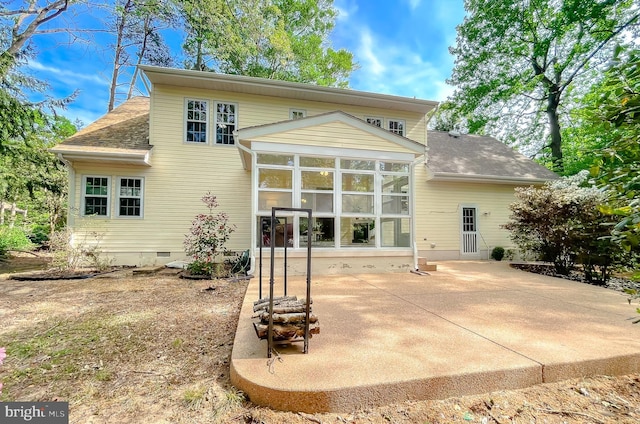 rear view of house featuring a sunroom, a shingled roof, crawl space, and a patio