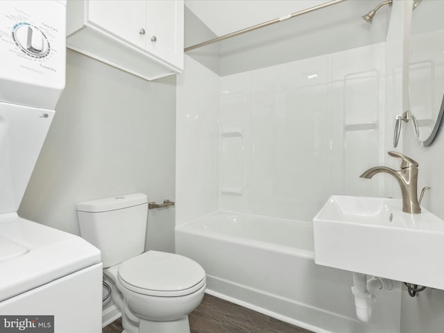 full bathroom featuring toilet, wood finished floors, a sink, and  shower combination