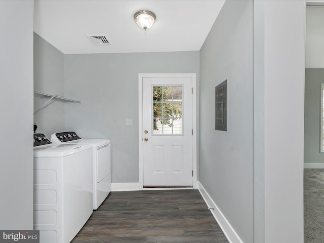 washroom featuring dark wood-style floors, washer and clothes dryer, laundry area, visible vents, and baseboards