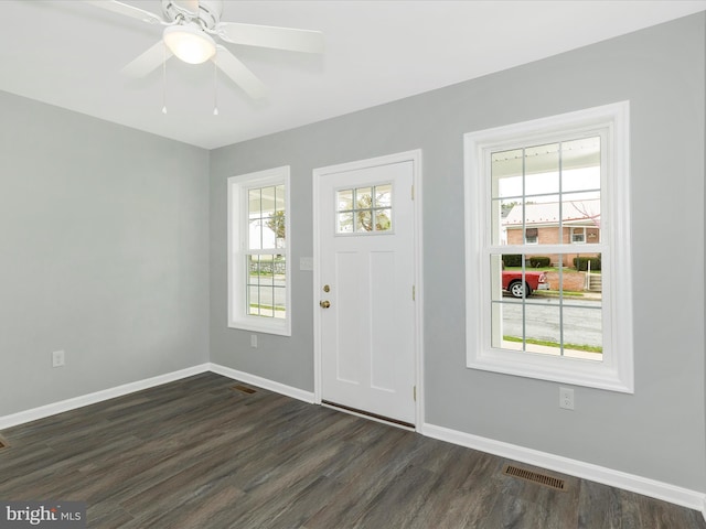 entrance foyer with baseboards, a ceiling fan, visible vents, and dark wood-type flooring