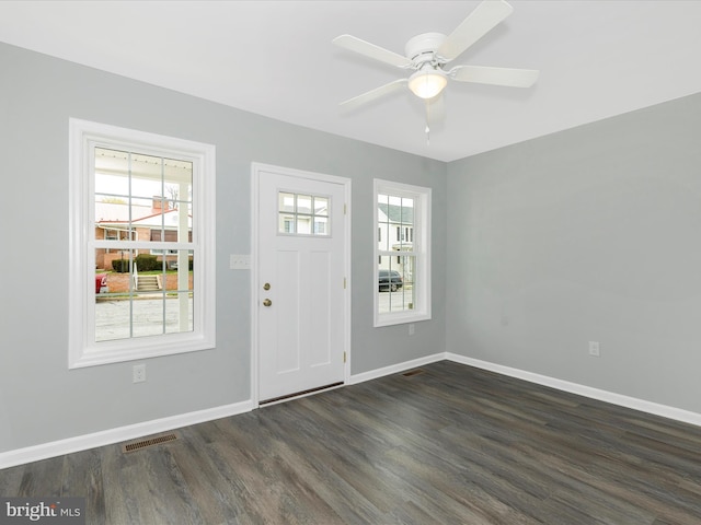 foyer with a ceiling fan, baseboards, visible vents, and dark wood-style floors