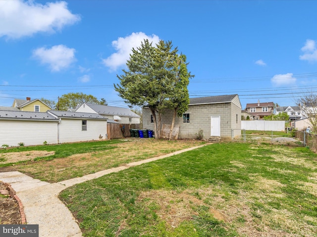 view of yard featuring entry steps and fence