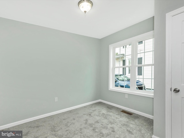 carpeted empty room with baseboards and visible vents
