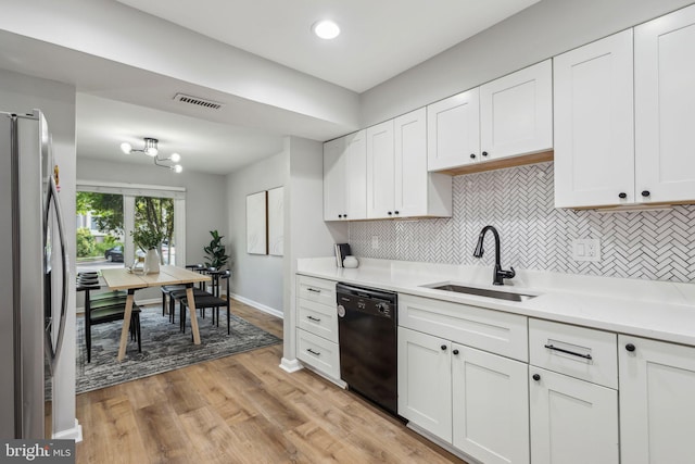 1070 Trevino Ln, Herndon, VA 20170 - kitchen with visible vents, decorative backsplash, black dishwasher, stainless steel refrigerator with ice dispenser, and a sink