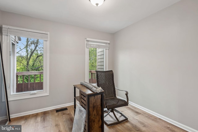 1070 Trevino Ln, Herndon, VA 20170 - living area with baseboards, visible vents, a wealth of natural light, and wood finished floors