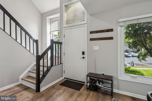 1070 Trevino Ln, Herndon, VA 20170 - entrance foyer with stairway, baseboards, vaulted ceiling, and wood finished floors