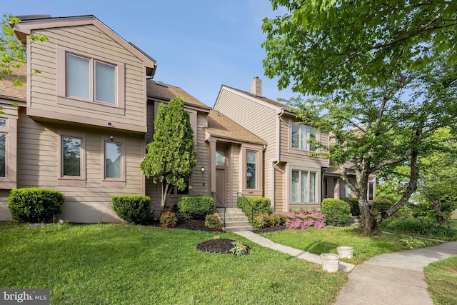 1070 Trevino Ln, Herndon, VA 20170 - townhome / multi-family property with a chimney and a front lawn