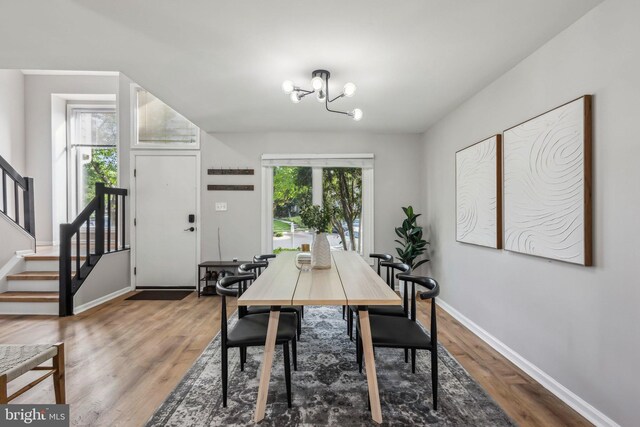 1070 Trevino Ln, Herndon, VA 20170 - dining area featuring baseboards, a chandelier, wood finished floors, and stairway