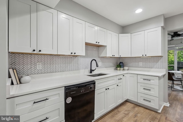 1070 Trevino Ln, Herndon, VA 20170 - kitchen featuring decorative backsplash, light wood-type flooring, dishwasher, a sink, and white cabinets