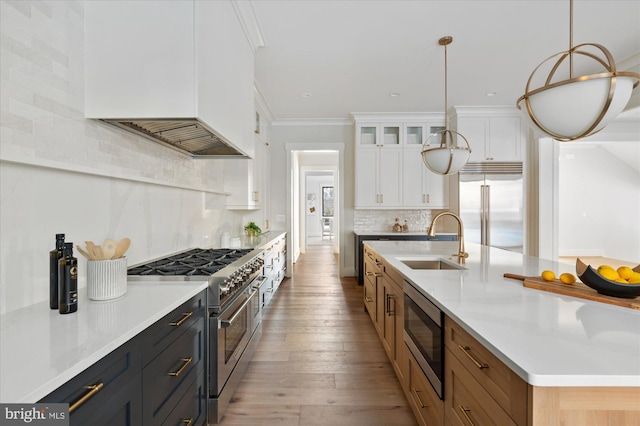 6221 Nelway Dr, Mclean, VA 22101 - kitchen with white cabinets, a sink, decorative backsplash, a kitchen island with sink, and built in appliances