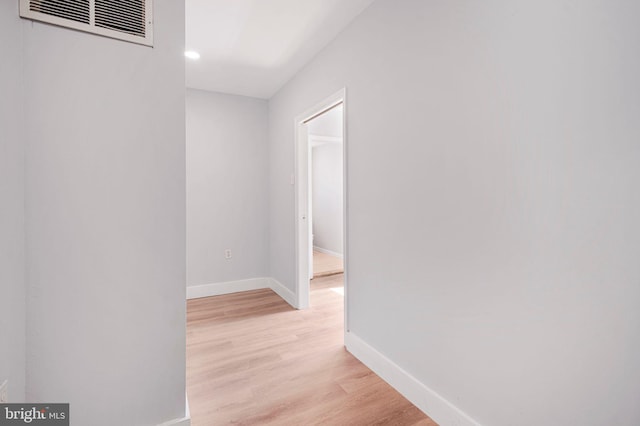 corridor featuring recessed lighting, baseboards, light wood-type flooring, and visible vents