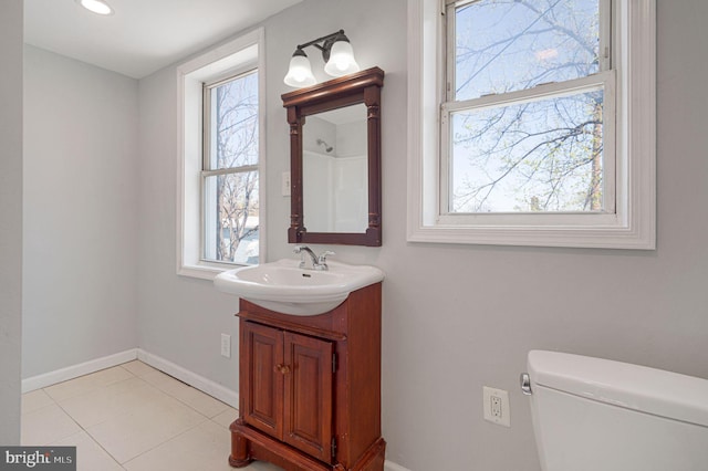 bathroom with toilet, baseboards, recessed lighting, and vanity