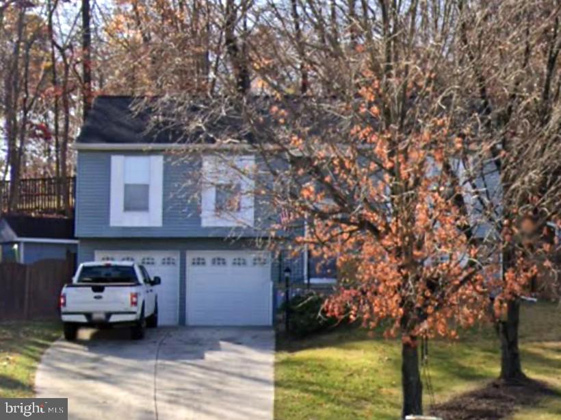 6118 Arrowwood Ct, Hanover, MD 21076 - view of front facade featuring concrete driveway, a garage, and a front yard