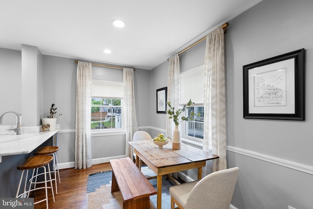 dining area with dark wood finished floors, baseboards, and recessed lighting