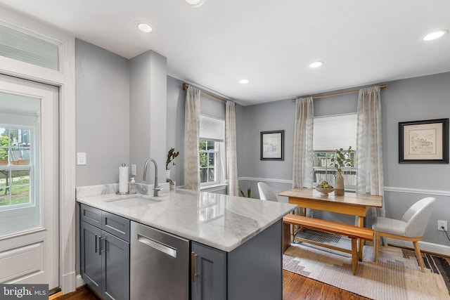 kitchen with stainless steel dishwasher, a sink, gray cabinetry, healthy amount of natural light, and recessed lighting