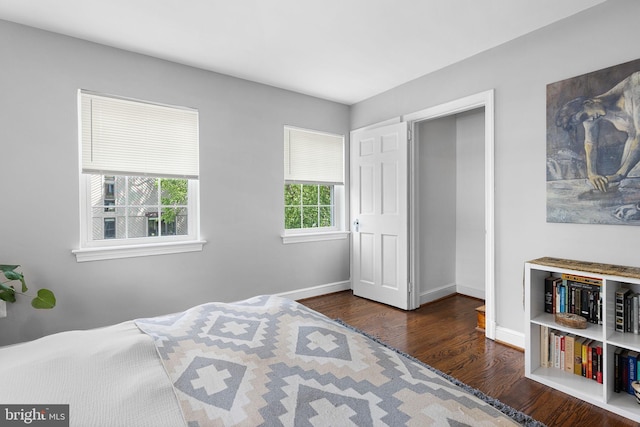 bedroom with wood finished floors and baseboards
