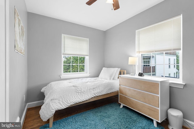 bedroom featuring baseboards, a ceiling fan, and wood finished floors