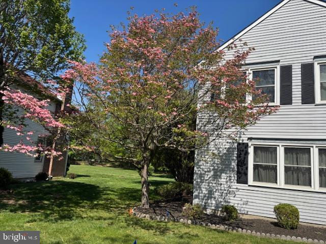 view of side of home with a yard