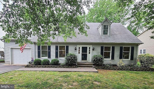 813 Petinot Pl, Stevensville, MD 21666 - cape cod house featuring an attached garage, asphalt driveway, and a front yard