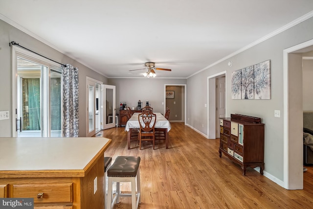 813 Petinot Pl, Stevensville, MD 21666 - dining space with light wood-style floors, a ceiling fan, crown molding, and baseboards