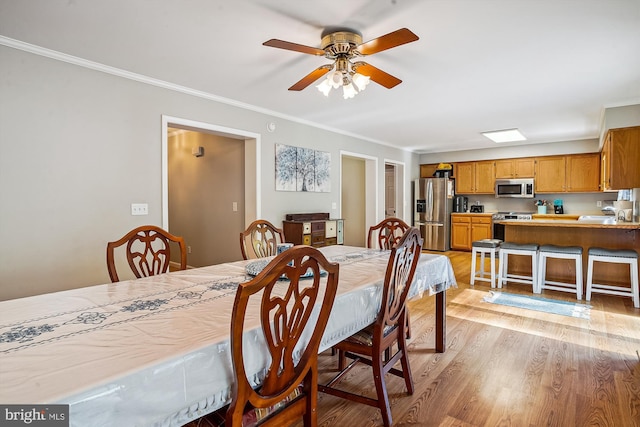 813 Petinot Pl, Stevensville, MD 21666 - dining space with light wood finished floors, crown molding, and a ceiling fan