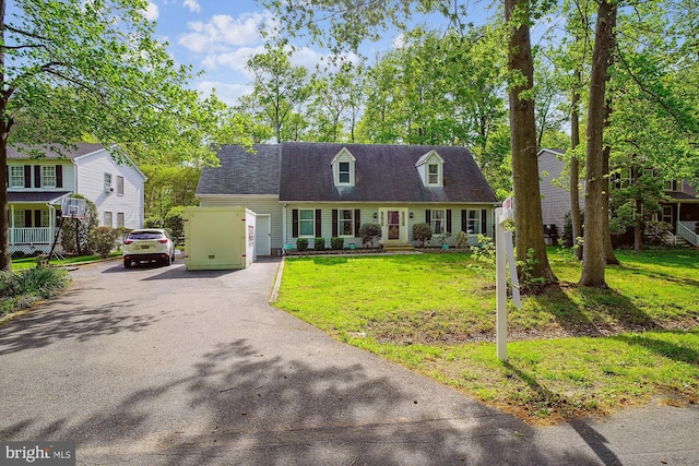 813 Petinot Pl, Stevensville, MD 21666 - cape cod home featuring asphalt driveway and a front lawn