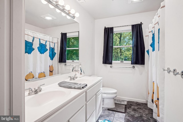 813 Petinot Pl, Stevensville, MD 21666 - full bath with toilet, double vanity, tile patterned floors, baseboards, and curtained shower