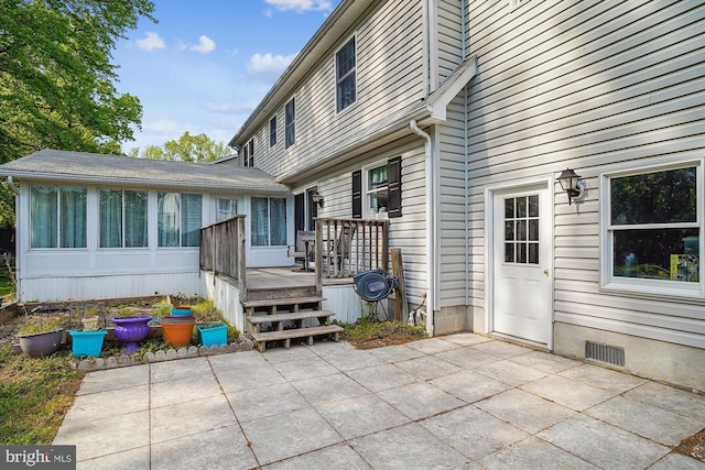 813 Petinot Pl, Stevensville, MD 21666 - back of house with a patio area, a deck, and a sunroom