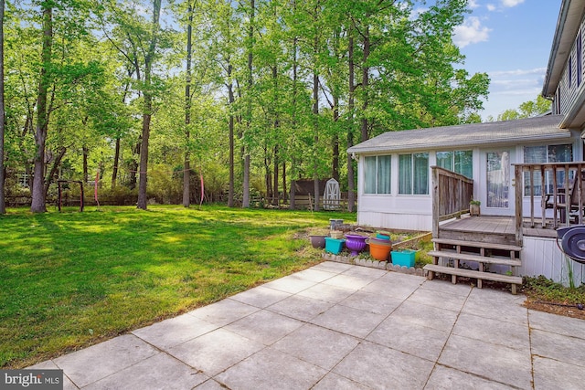 813 Petinot Pl, Stevensville, MD 21666 - view of grassy yard featuring a patio area, a wooden deck, and a sunroom