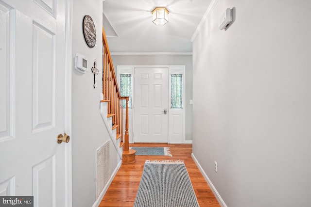 813 Petinot Pl, Stevensville, MD 21666 - entrance foyer featuring ornamental molding, light wood finished floors, stairway, and baseboards