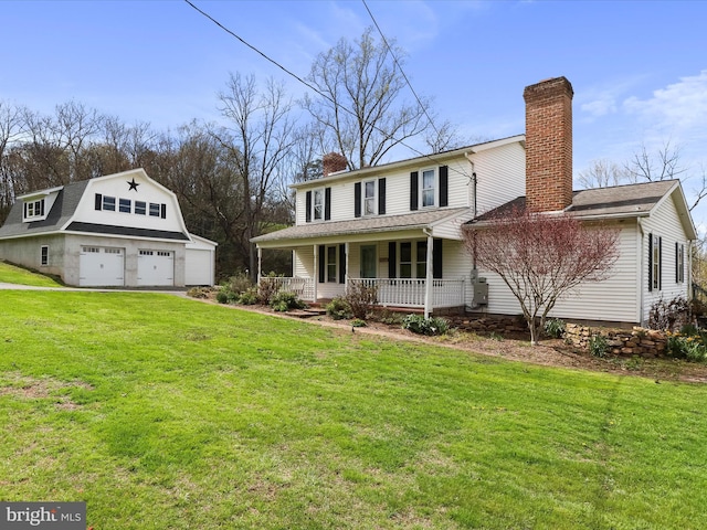 2297 Big Cove Tannery Rd, Big Cove Tannery, PA 17212 - view of front of home featuring a garage, a chimney, a porch, an outbuilding, and a front yard