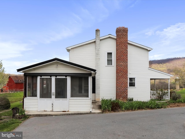2297 Big Cove Tannery Rd, Big Cove Tannery, PA 17212 - rear view of house featuring a chimney and a sunroom