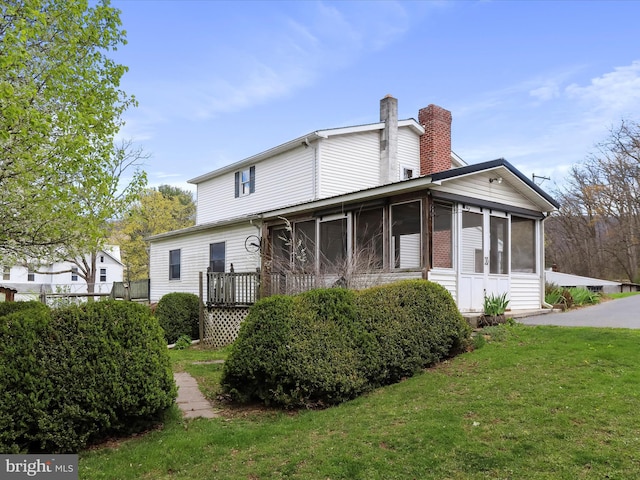 2297 Big Cove Tannery Rd, Big Cove Tannery, PA 17212 - rear view of property with a chimney, a sunroom, and a yard
