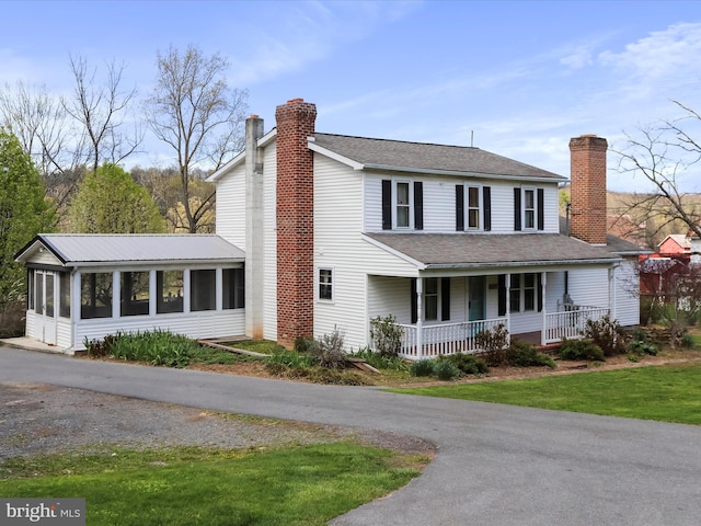 2297 Big Cove Tannery Rd, Big Cove Tannery, PA 17212 - view of front of house with a chimney, a sunroom, a porch, and roof with shingles