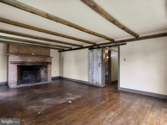 2297 Big Cove Tannery Rd, Big Cove Tannery, PA 17212 - unfurnished living room with a barn door, baseboards, wood finished floors, and beam ceiling