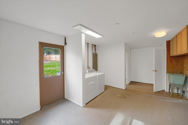 clothes washing area featuring electric panel, a sink, independent washer and dryer, and laundry area